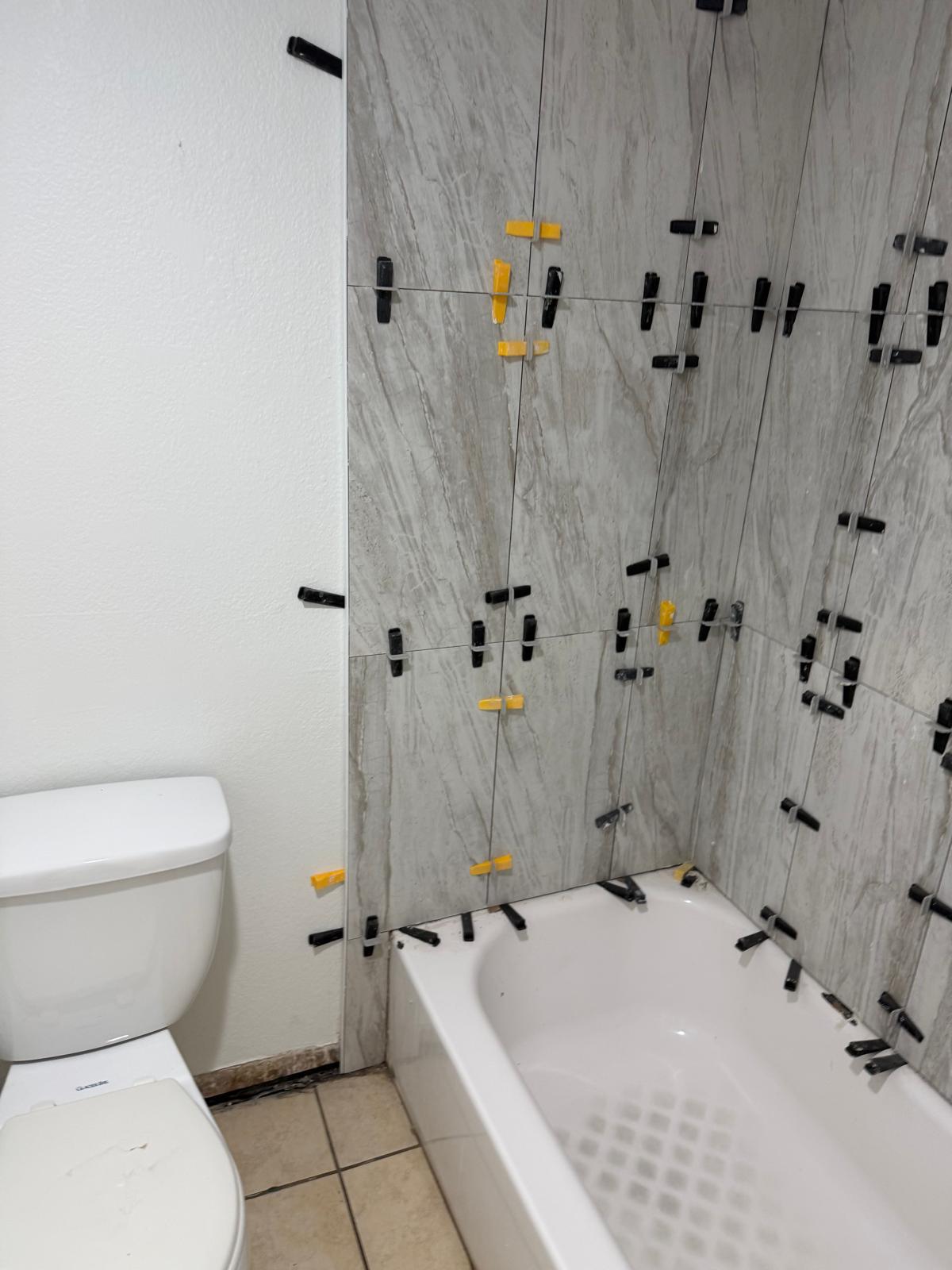 Gray tile installation with spacers