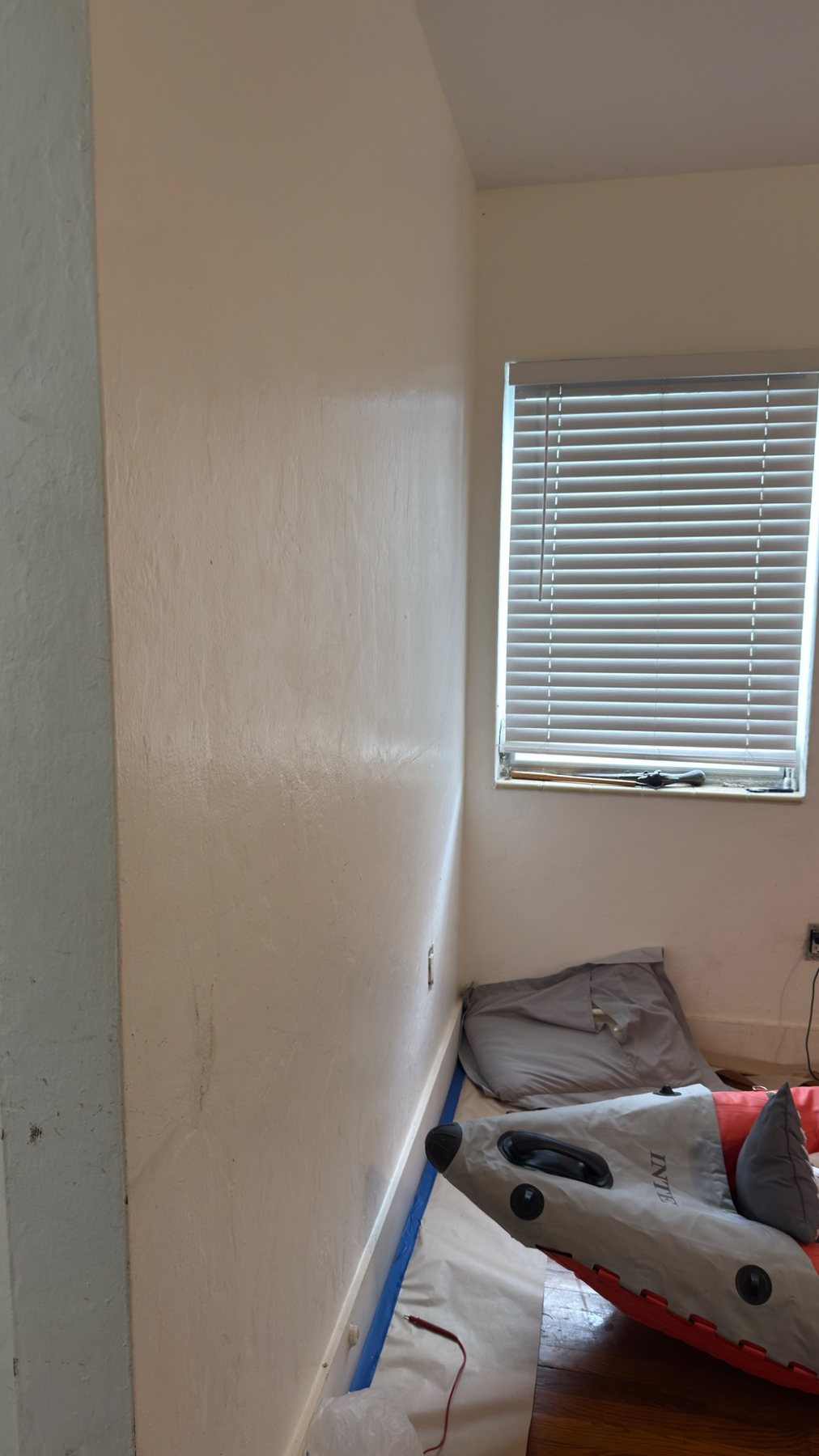 Bedroom corner before repairs and painting